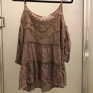 A brown blouse with cut outs